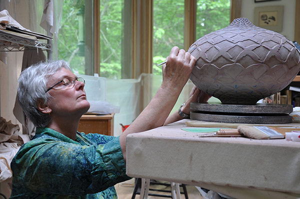 Photo of Judith Ernst working in her studio