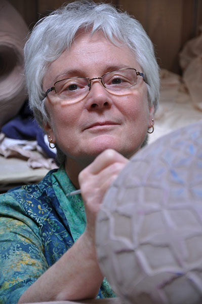 Photo of Judith Ernst working in her studio